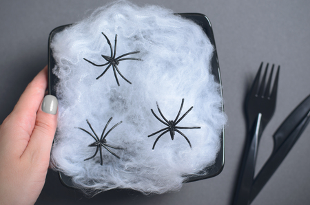 Top View of Halloween Plate with Cobweb and Spiders on Dark Background, Halloween Holiday Party Dinner Conceptの写真素材