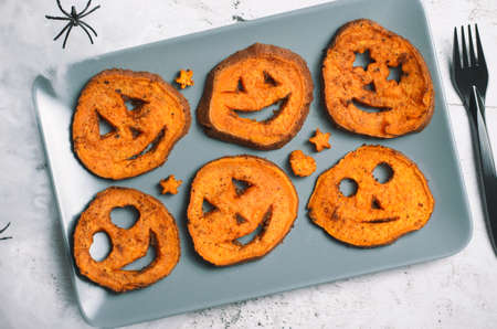 Roasted Sweet Potato Carving Funny Faces, Halloween Symbol Creative Food for Kidsの写真素材