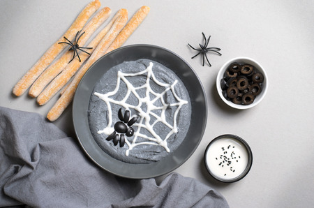Black Hummus Halloween Dip Decorated with Cobweb and Spider, Halloween Spooky Party Treatの写真素材