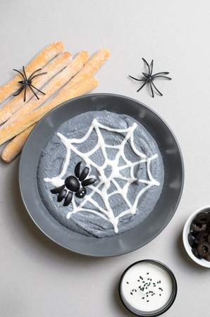 Black Hummus Halloween Dip Decorated with Cobweb and Spider, Halloween Spooky Party Treatの写真素材
