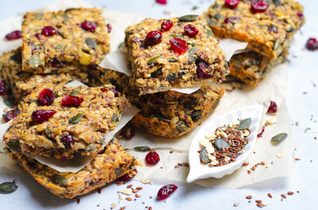Granola Bars, Healthy Homemade Snack, Superfood Bars with Cranberry, Pumpkin Seeds, Oats, Chia and Flax Seed on bright background, Vegan Mealの写真素材