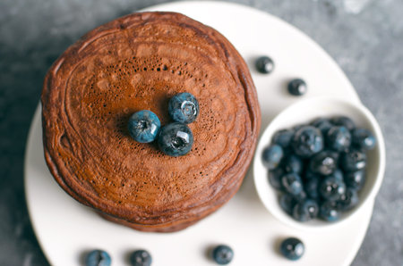 Chocolate Pancakes with Blueberry on grey background, Homemade Dessert, Tasty Sweet Breakfastの写真素材