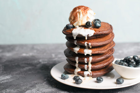 Chocolate Pancakes with Blueberry and Ice Cream on grey background, Homemade Dessert, Tasty Sweet Breakfastの写真素材