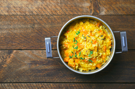 Delicious Pumpkin Risotto with Thyme and Parmesan in a Vintage Pot, Italian Cuisineの写真素材