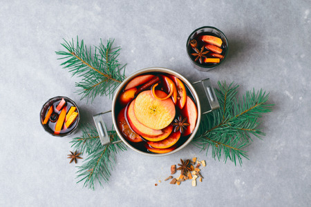 Mulled Wine, Hot Spiced Drink with Orange and Apple in a Vintage Pot, Winter Beverageの写真素材