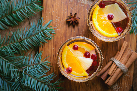 Winter Cocktail, Christmas Sangria with Apple Slices, Orange, Cranberry and Cinnamon, Refreshing Drink on Woodenの写真素材