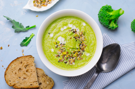 Green Vegan Broccoli Cream Soup with Non-Dairy Cashew Milk and Seed Mix, Detox Healthy Eating, Delicious Vegetarian Mealの写真素材