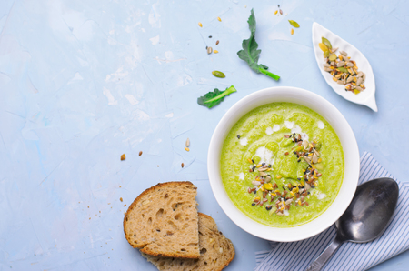 Green Vegan Broccoli Cream Soup with Non-Dairy Cashew Milk and Seed Mix, Detox Healthy Eating, Delicious Vegetarian Mealの写真素材