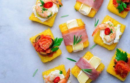 Polenta Bites with Different Toppings, Variety of Polenta Appetizers, Delicious Snack, Top Viewの写真素材