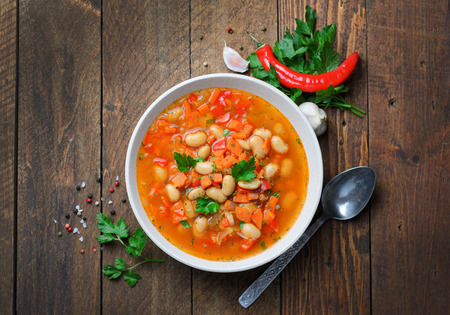 Vegetable Soup with White Beans, Homemade Soup on Dark Wooden Background, Vegetarian Food, Top Viewの写真素材