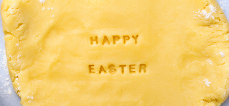 Easter Baking Background, Dough with Happy Easter Lettering, Festive Conceptの写真素材