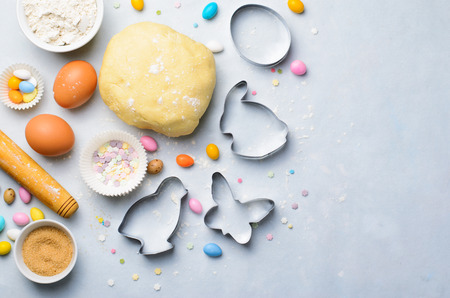 Making of Easter Cookies, Dough, Cookie Cutters, Sugar Sprinkles, Festive Easter Baking Backgroundの写真素材