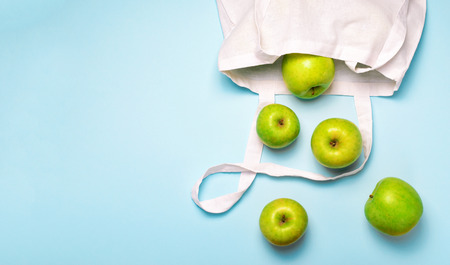 Apples in Cotton Bag, Zero Waste Concept, Eco Friendly Shopping Bag over Light Blue Backgroundの写真素材