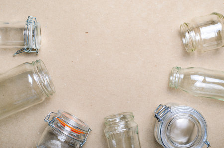 Variety of Glass Jars and Bottles, Zero Waste Shopping Concept, Storage Jars over Beige Craft Paper...