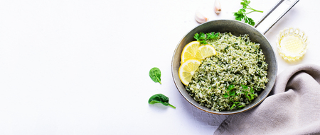 Spinach Rice in a Skillet over White Background, Green Rice, Healthy Vegetarian Foodの写真素材