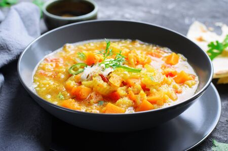 Rice and Pumpkin Indian Soup with Flat Bread on Dark Backgroundの写真素材