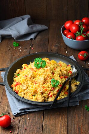 Chicken and Vegetables Bulgur in a Pan over Wooden Background, Tasty Mealの写真素材