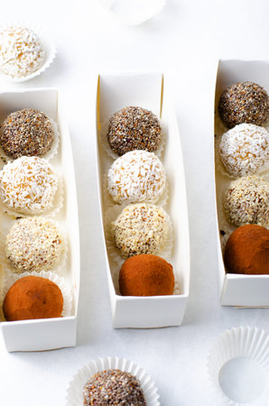 Assorted vegan sweets, Delicious Candy Balls with seeds, dried fruit and cocoa powder, Healthy...