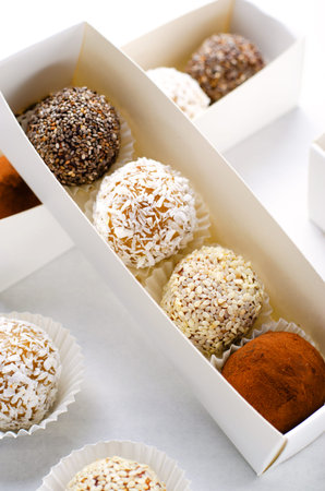 Assorted vegan sweets, Delicious Candy Balls with seeds, dried fruit and cocoa powder, Healthy...