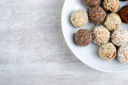 Assorted vegan sweets, Delicious Candy Balls with seeds, dried fruit and cocoa powder, Healthy...