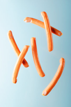 Sausages Levitating, Flying Food Concept, Light Blue backgroundの写真素材