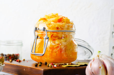 Sauerkraut, Shredded cabbage, apples, and carrots on bright rustic background, Healthy Eating,...