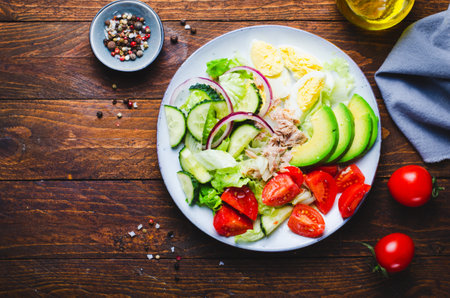 Tuna Salad, Healthy Food, Fresh Salad with Lettuce, Avocado, Cherries, Cucumber and Eggs on a Plateの写真素材