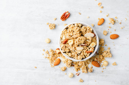 Granola with Nut Mix on Bright Concrete Background, Healthy Snack or Breakfastの写真素材