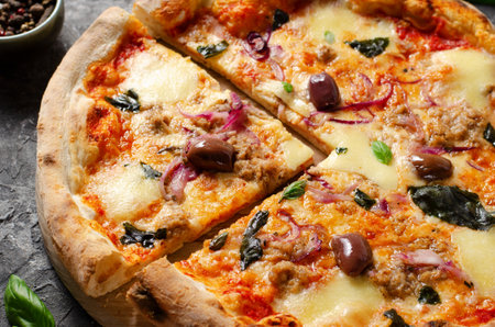 Tuna Pizza, Freshly Baked Pizza with Tuna, Mozzarella, Onion, Basil, and Olives on Dark Rustic Backgroundの写真素材