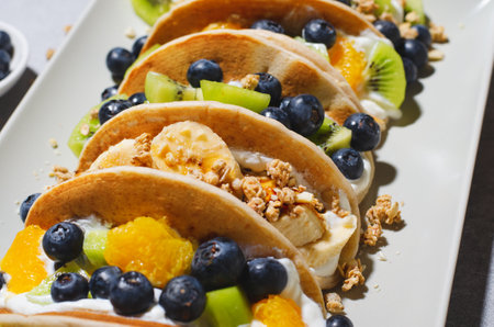 Taco Pancakes with Fresh Fruits, Blueberry and Yogurt Filling, Healthy Breakfast or Snack on Bright Backgroundの写真素材
