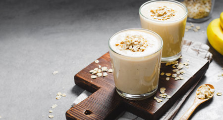 Banana Smoothie with Oats, Healthy Food, Vegan or Vegetarian Diet Food Concept, Grey Concrete Backgroundの写真素材