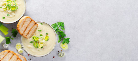 Leek Soup, Comfort Meal, Potato and Leek Creamy Soup, Vegetarian Food on Bright Grey Backgroundの写真素材