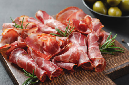 Cured Meat Platter, Antipasto, Appetizer on a Boardover Dark Backgroundの写真素材