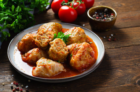 Homemade Cabbage rolls with meat, rice and vegetables. Stuffed cabbage leaves also known as sarma, golubtsy, dolma on Dark Rustic Backgroundの写真素材