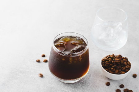 Iced Coffee, Cold Brew Coffee with Ice on Bright Light Grey Background, Refreshing Beverageの写真素材