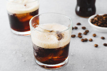 Iced Coffee, Sparkling or Cold Brew Coffee with Ice on Bright Light Grey Background, Refreshing...