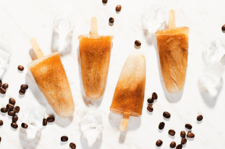 Coffee , Refreshing Ice Lollies with Coffee Beans and Ice on Bright Background, Tasty Frozen Treatの写真素材