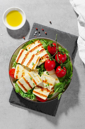 Grilled Halloumi Cheese with Cherry Tomatoes, Tasty Appetizer, Salad, Ketogenic, Paleo Lunch on Bright Backgroundの写真素材