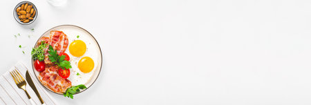 Fried Eggs and Bacon with Cherry Tomatoes on Plate, Breakfast, Keto, Paleo Diet Lunch on Bright Backgroundの写真素材