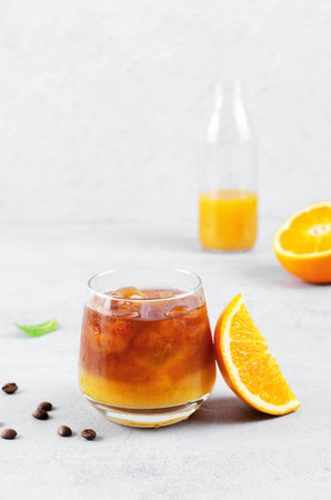Bumble Coffee, Coffee with Orange Juice with Ice, Refreshing Drink on Light Grey Background
