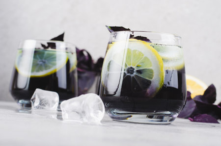 Basil Lemonade, Refreshing Summer Cocktail, Infused Water, Iced Tea, Lemon and Basil Cold Drink on Bright Backgroundの写真素材