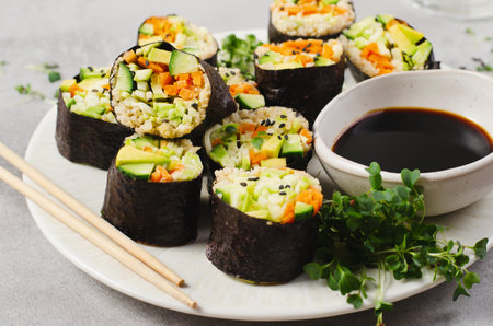 Vegan Sushi Rolls with Fresh Vegetables and Quinoa, Tasty Vegetarian Meal on Bright Backgroundの写真素材