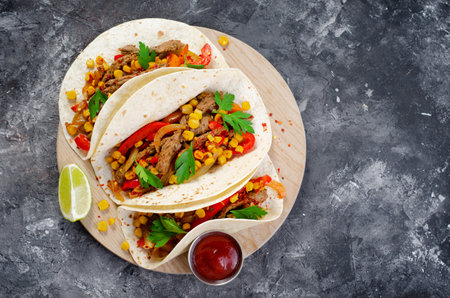 Mexican Tacos with Beef and Vegetables, Tacos al Pastor on Dark Rustic Backgroundの写真素材