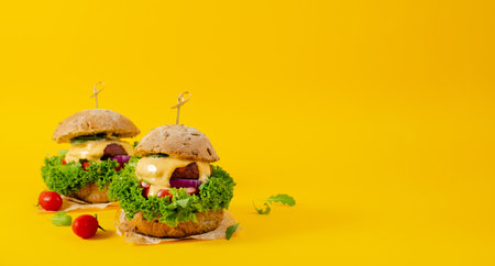 Delicious Burgers with Vegetables and Sauce, Plant Based Meatless Burgers on Yellow Backgroundの写真素材