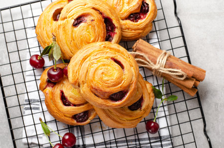 Freshly Baked Puff Pastry with Cherries on Bright Light Grey Backgroundの写真素材