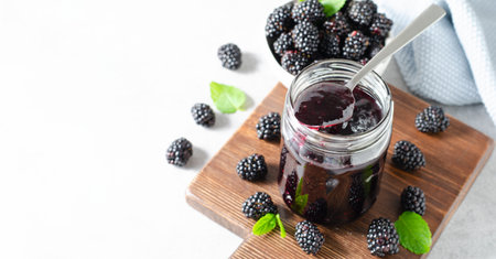 Blackberry Jam in a Jar, Tasty Homemade Berry Jam on Bright Backgroundの写真素材