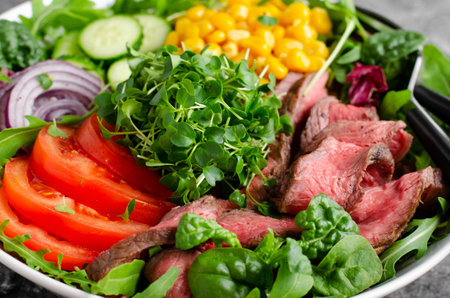 Beef steak and Fresh Vegetables Buddha Bowl, Tasty Healthy Balanced Meal on Dark Backgroundの写真素材