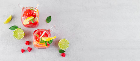 Refreshing Cold Cocktail or Mocktail with Berries and Lime, Raspberry Lemonade on Bright Backgroundの写真素材