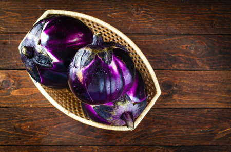 Fresh Eggplants over Dark Wooden Rustic Backgroundの写真素材