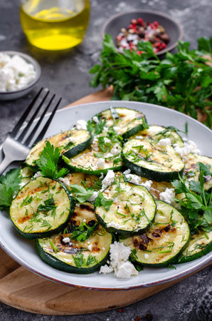 Grilled Zucchini, Feta and Herbs Warm Appetizer, Salad on Dark Rustic Backgroundの写真素材